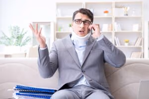 Man-in-neck-brace-talking-on-phone-to-personal-injury-lawyer